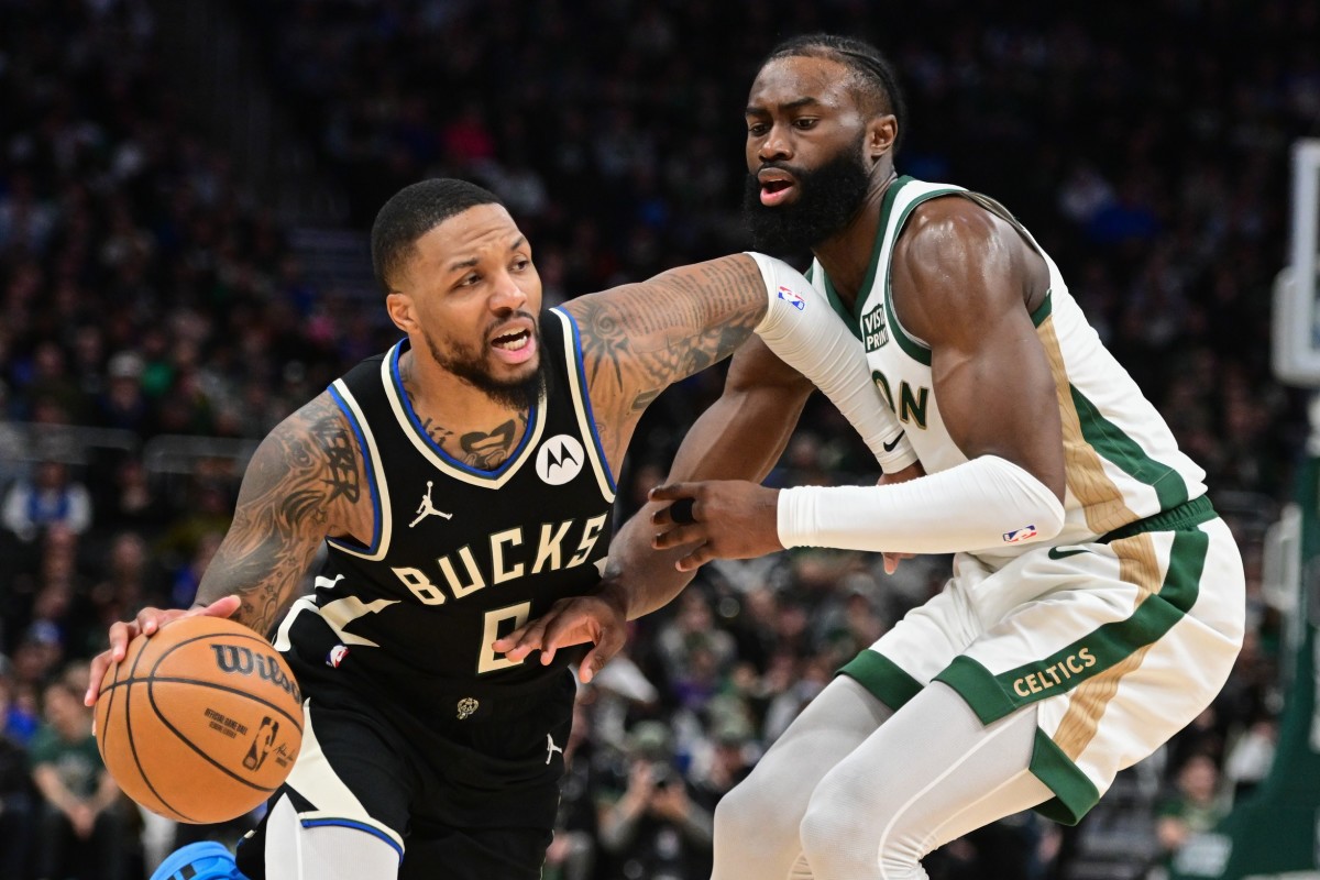 Milwaukee Bucks guard Damian Lillard (0) drives for the basket against Boston Celtics center Jaylen Brown (7) 